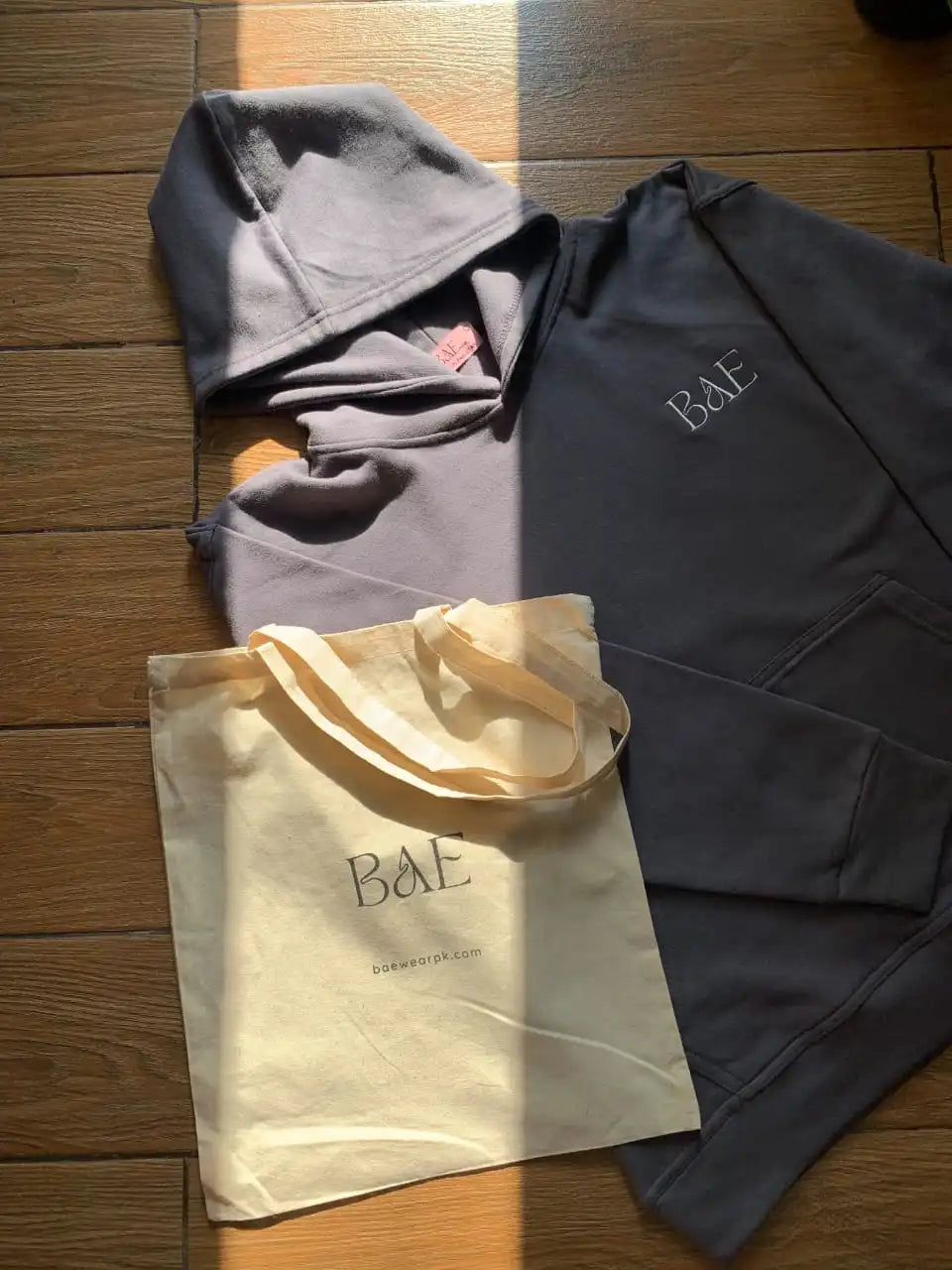 Grey color hoodie and a tote bag