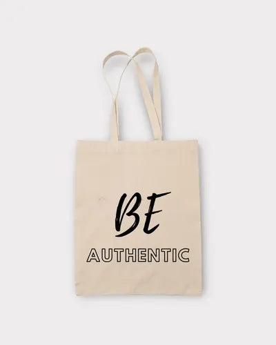 Beige tote bag with 'BE AUTHENTIC' text on a white background