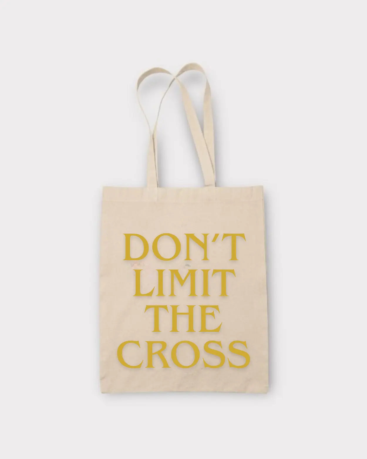 Beige tote bag with 'Don't Limit The Cross' text