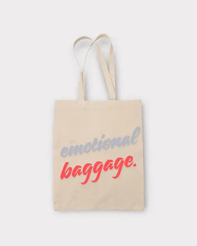 Beige tote bag with 'emotional baggage' text on a white background