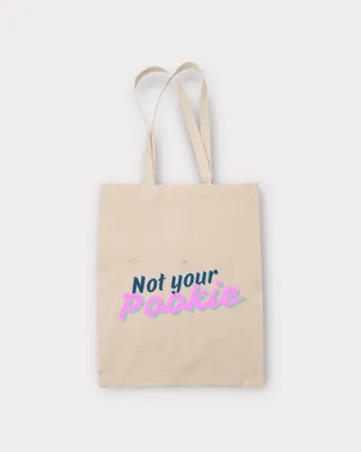 Beige tote bag with 'Not your Pookie' text on a white background