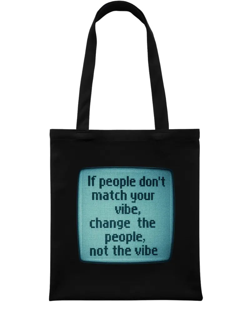 A black canvas tote bag with two black handles, featuring a central graphic of a retro television screen with a teal-blue background and the text, 'If people don't match your vibe, change the people, not the vibe'.