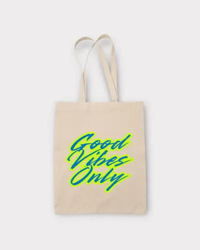 Beige tote bag with 'Good Vibes Only' text in green on a white background